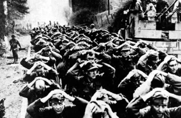 Soldaten der Deutschen Wehrmacht auf dem Weg in ein amerikanisches Kriegsgefangenenlager