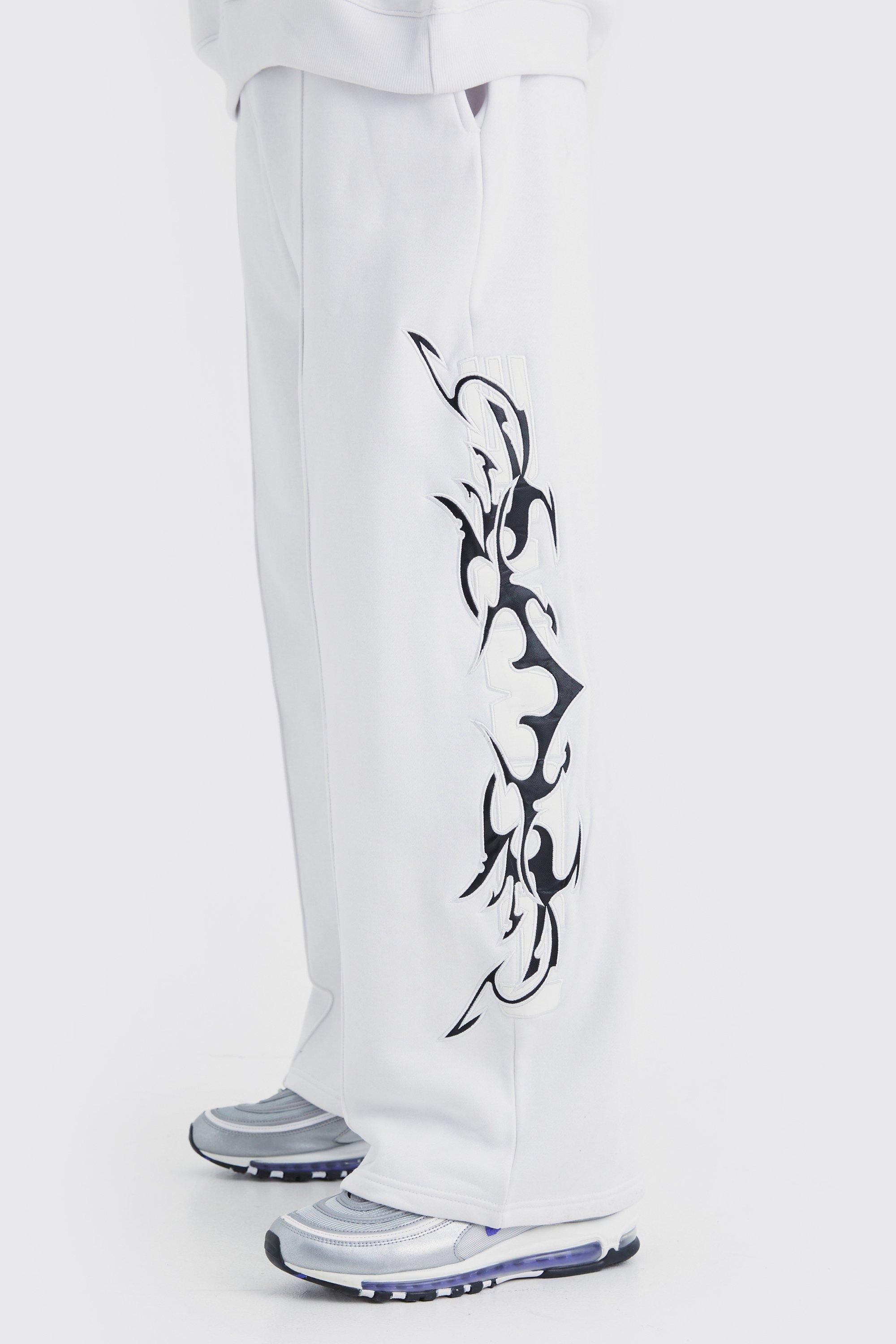 Image of Pantaloni tuta a gamba ampia con applique in PU, Bianco