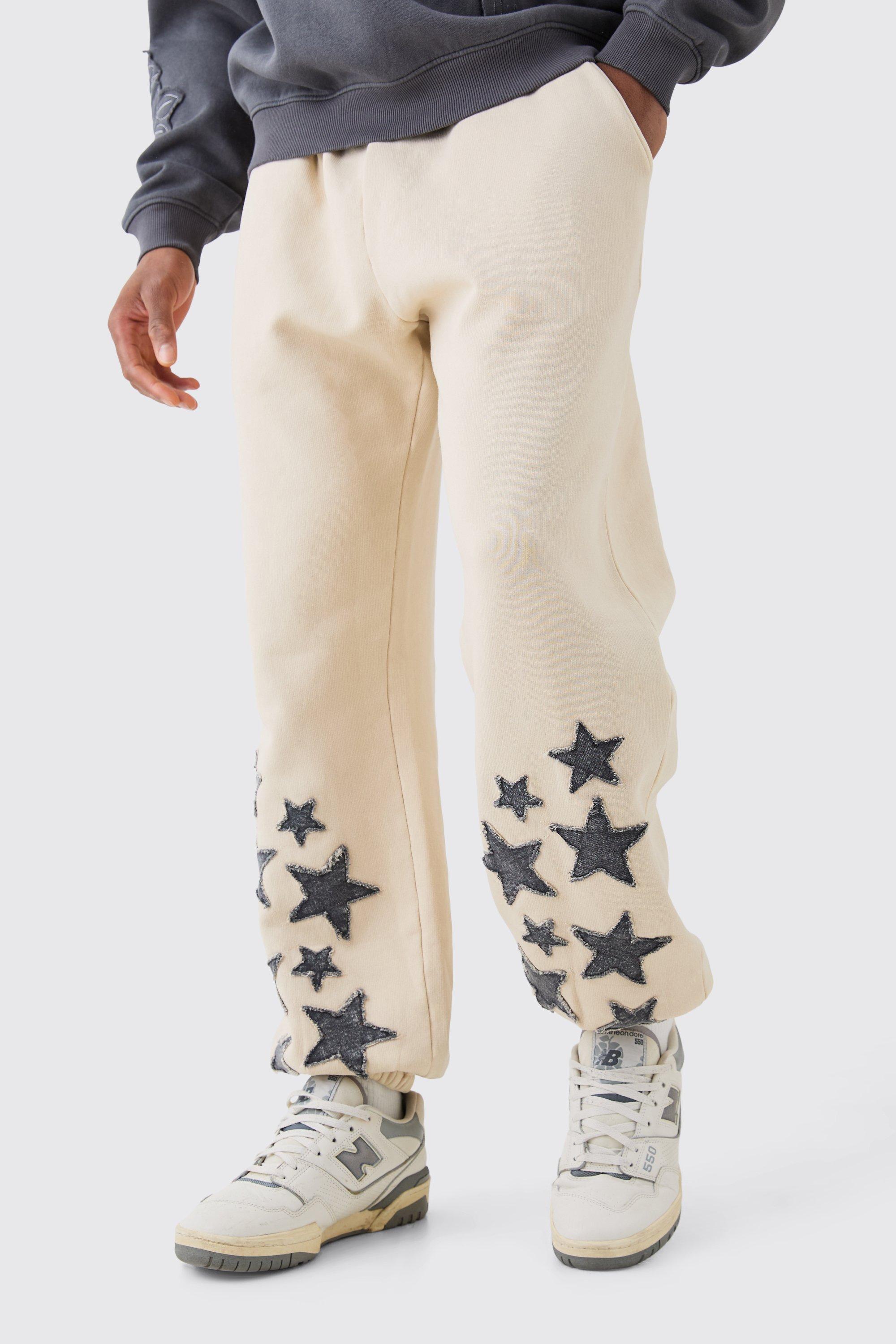 Image of Pantaloni tuta dritti in denim in lavaggio acido con applique di stelle, Beige