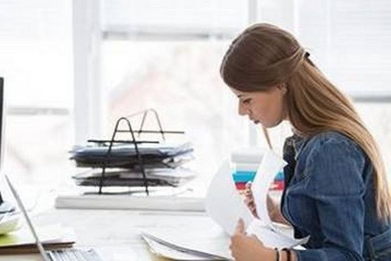 a woman reviewing invoices