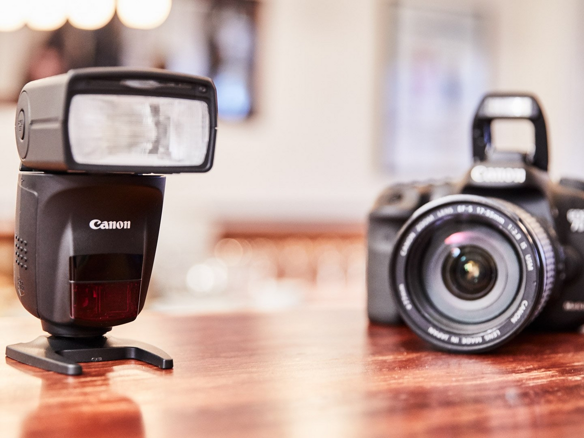 Canon 6D Mark II and Canon Speedlite 470EX-AI on a brown table