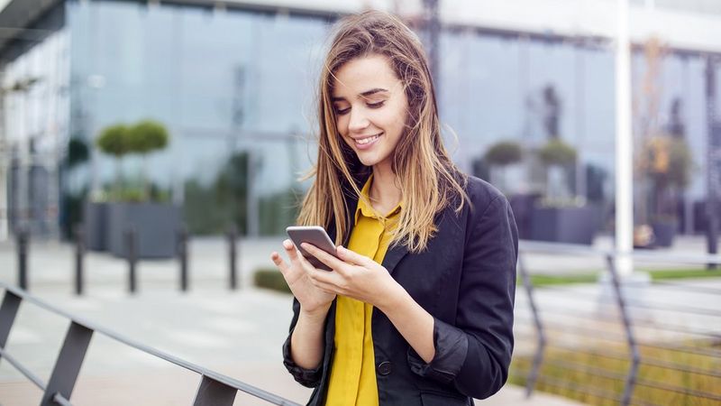 Work professional smiling at her phone