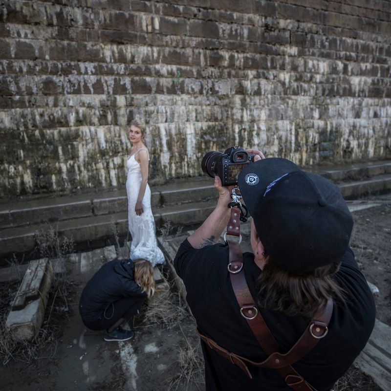 Photographer taking a picture of the bride with a Canon camera