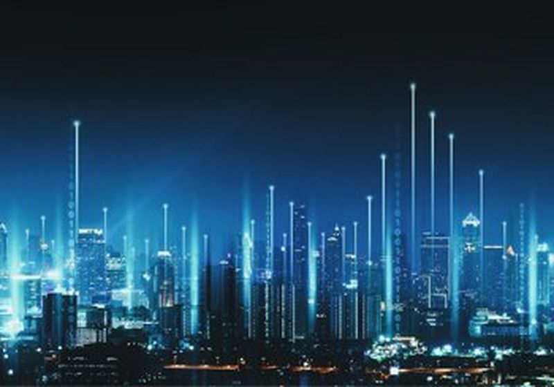A futuristic cityscape at night, with dozens of skyscrapers lit up in blue light.