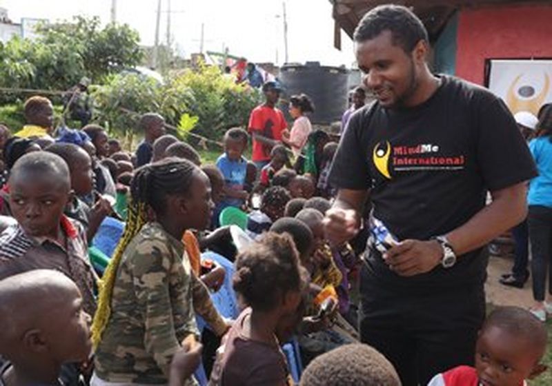 On the right, John Wambugu of MindMe International is surrounded by the children who use the Laibu Mtaani.