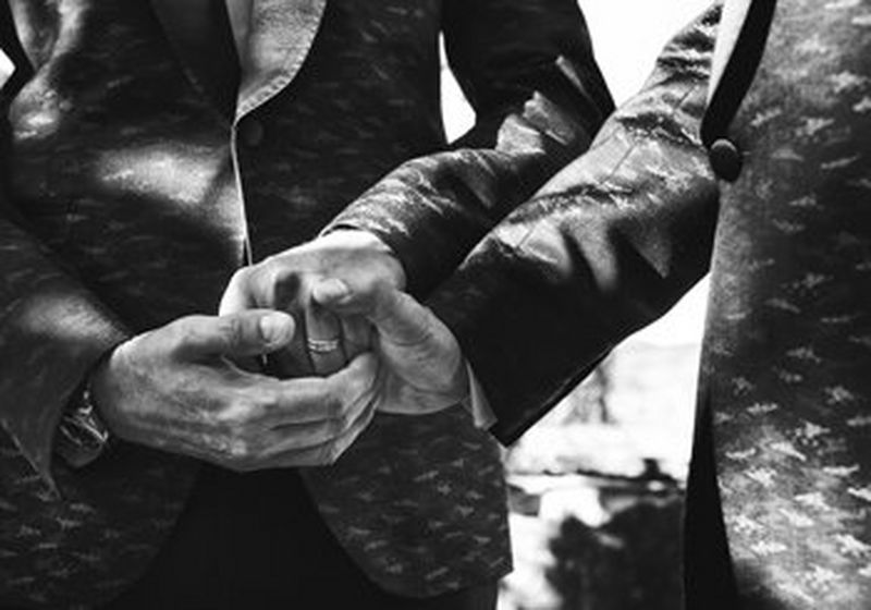 Close up of newly-weds holding hands