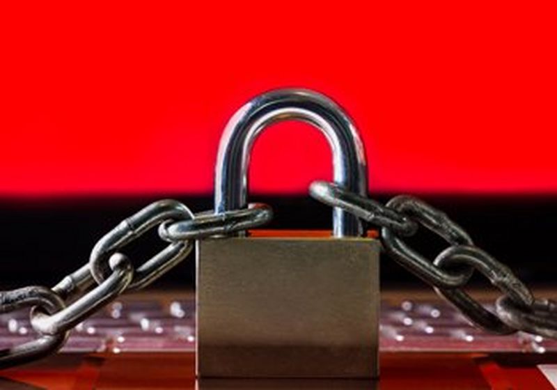 A padlock and chain on a red and black background.