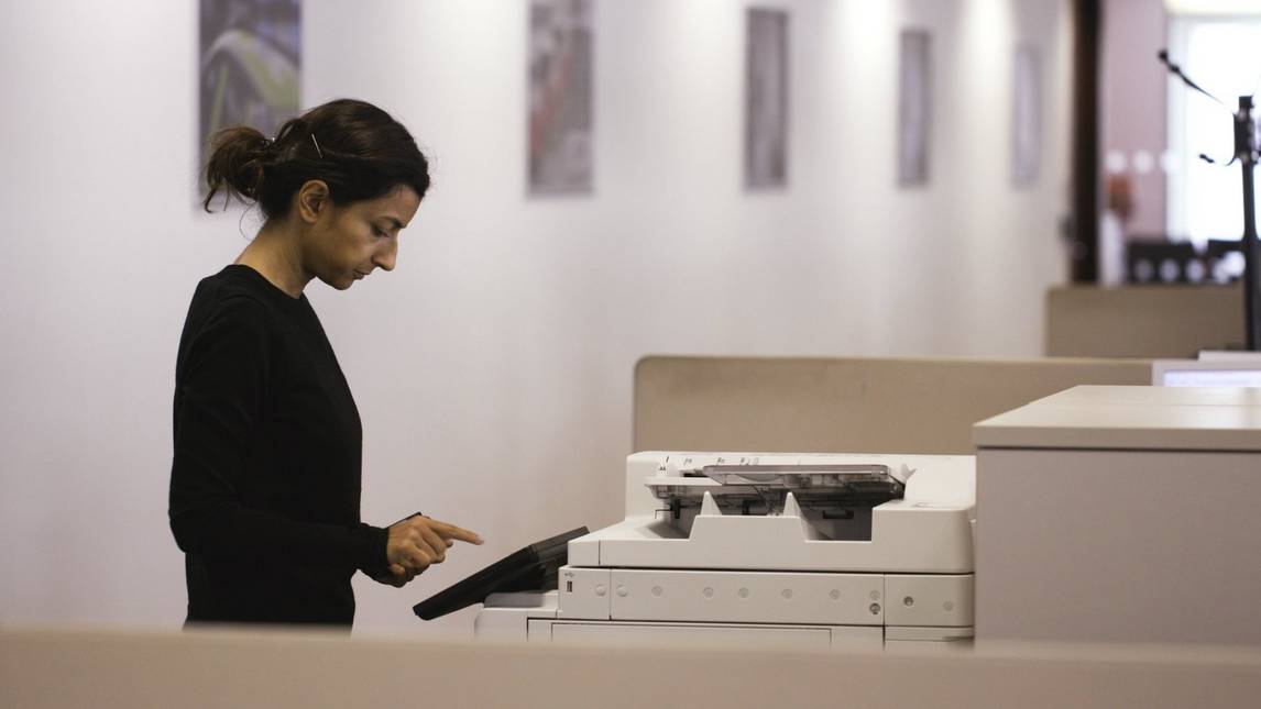 Woman using Canon multi-functional printer