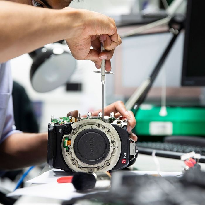 A specialist working on a Canon EOS C body
