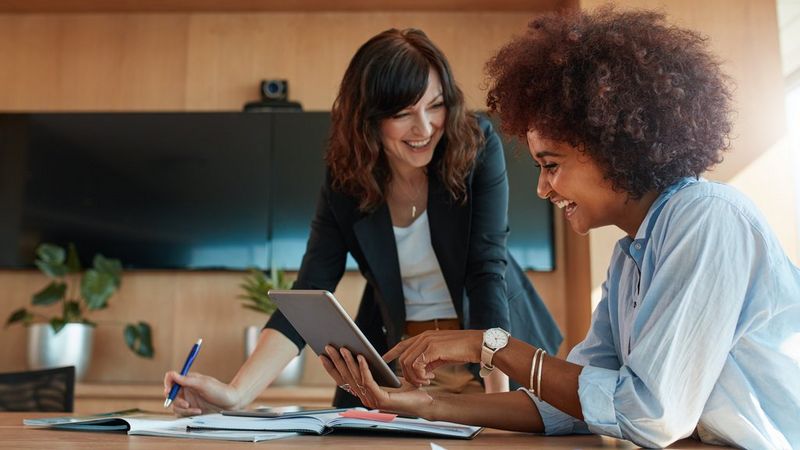 Two work professionals in the office laughing – Canon UK