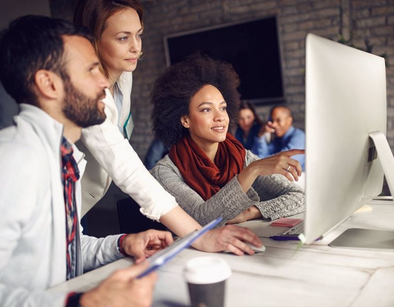 work professionals looking at a computer screen