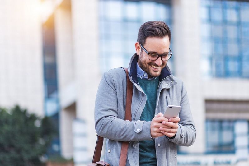 man looking at smartphone