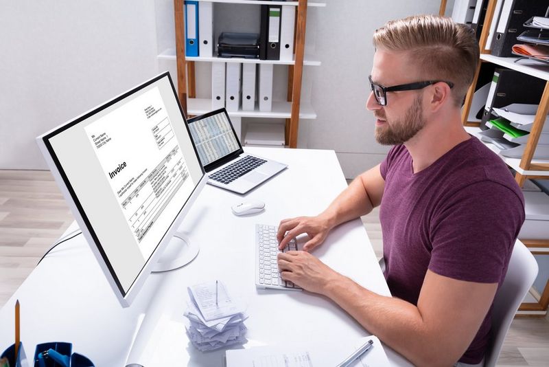A man looking at a computer screen