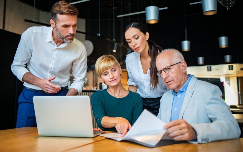 Work professionals in the office reviewing documents
