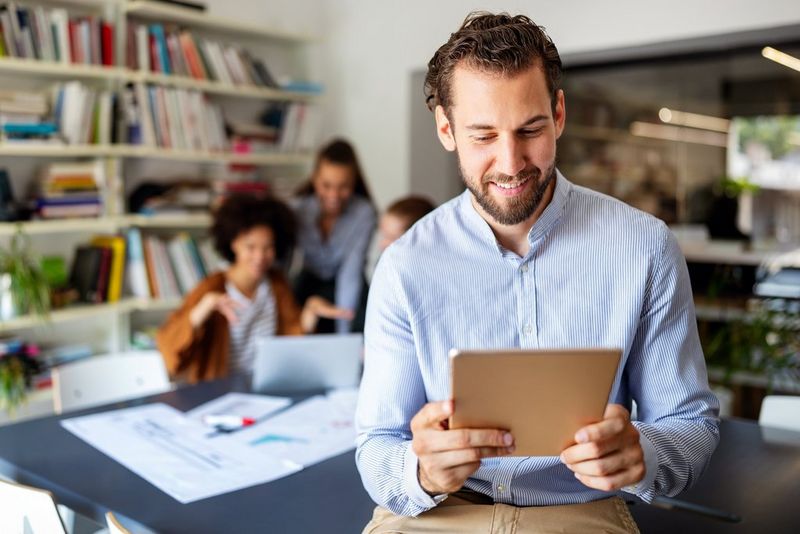 a man looking at a tablet