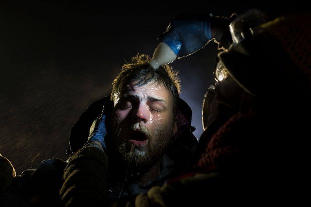 A man is treated after being pepper sprayed by police.