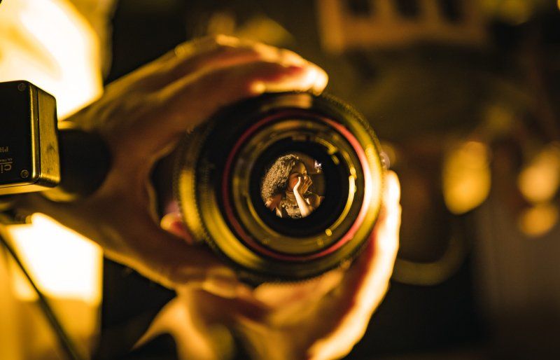 Laura Bingham pictured from behind, facing dense jungle, as she films a vlog with a Canon PowerShot G7 X Mark II.