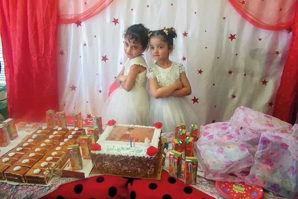 An image of a little girls' birthday party, celebrating with friends and cake.