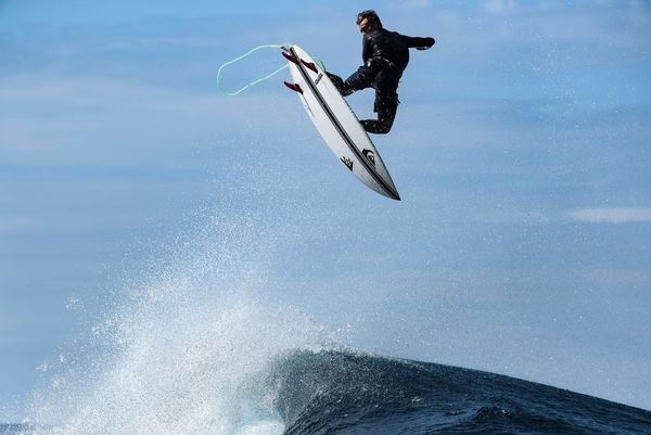 Kauli Vaast catches some air as he surfs in Tahiti. Photo by Ben Thouard taken on a Canon EOS-1D X Mark III.