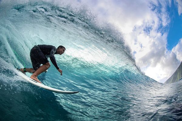 Surfer Kauli Vaast photographed with a fisheye lens as he rides a breaking wave.