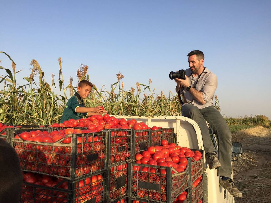 Canon Ambassador Ivor Prickett takes a photo of an Iraqi boy on a tomato truck. 