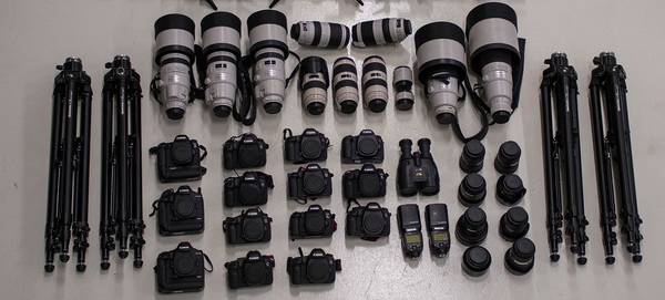 The contents of motorsports photographer Frits van Eldik's kitbag, including 14 Canon camera bodies and several telephoto lenses.