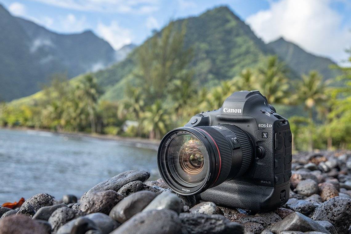 A Canon EOS-1D X Mark III on some rocks by the sea.