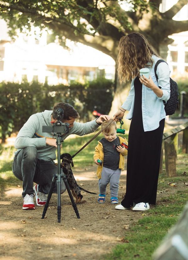 Stefan Michalak filming with his wife, son and dog in the park.  