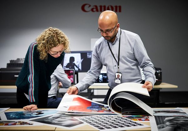 Helen Bartlett with Canon Inkjet Specialist Suhaib Hussain looking through an A2 book of prints. 