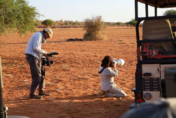 Alex Wykes films Marina Cano as she kneels in the desert sand and shoots with a Canon EOS-1D X Mark III.