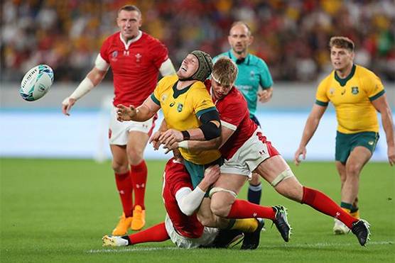 Two Wales players tackle an Australian player in the Walves v Australia match at Rugby World Cup 2019™. Taken by sports photographer Warren Little on a Canon EOS-1D X Mark II.