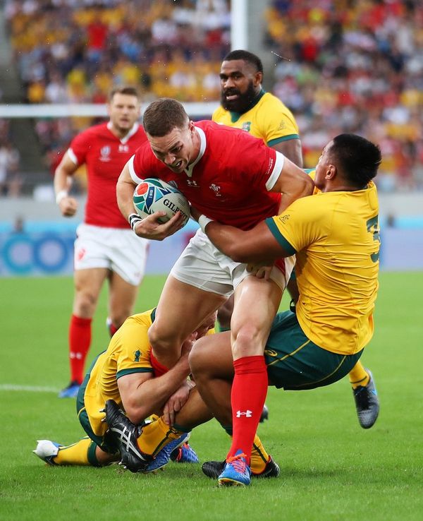 Wales player George North tries to stride through an Australian tackle in the Wales v Australia match at Rugby World Cup 2019™, photographed by Warren Little on a Canon EOS-1D X Mark II.