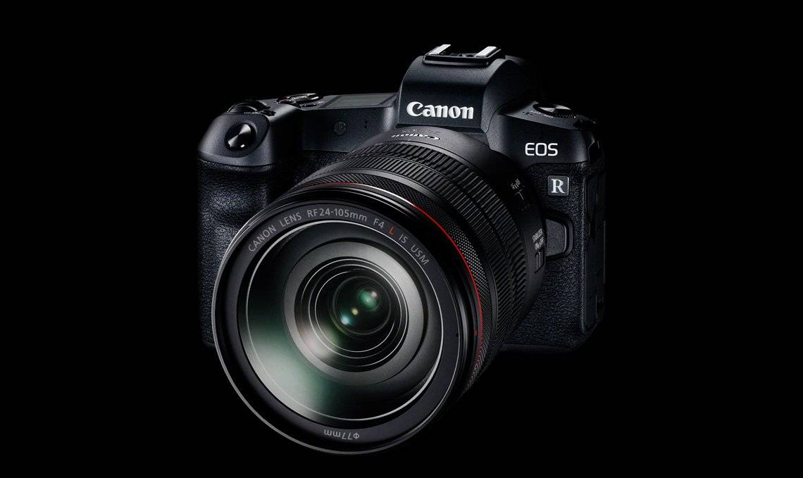 A Canon EOS R camera is pictured in front of a black background.
