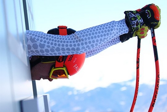 A close-up of a skier preparing to launch himself down a slope