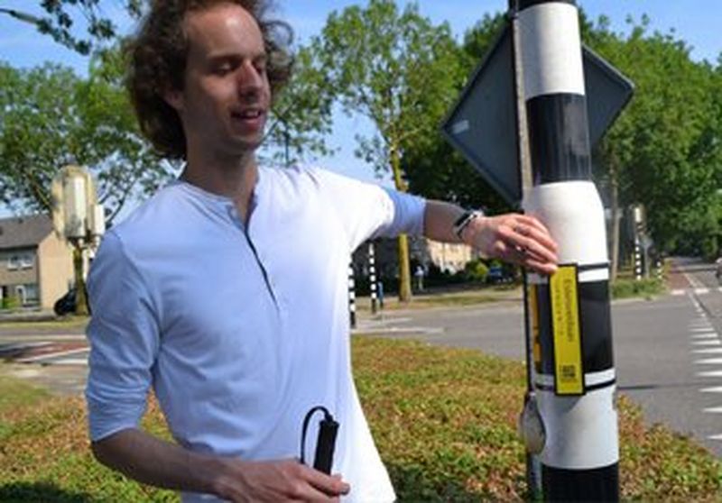 Visually impaired man using QR code at crossing