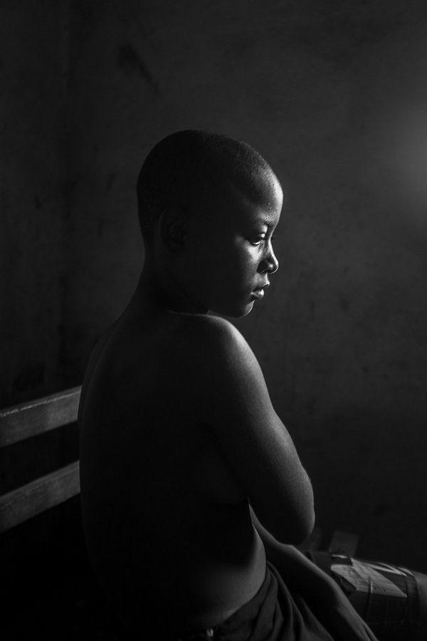 Kamini Tontines, a 12-year-old in Cameroon, is hiding her breasts after having them ironed by her mother. 