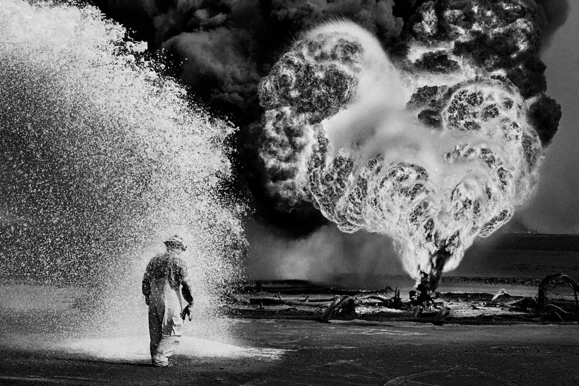 Sebastião Salgado’s black-and-white picture of firefighters tackling the Kuwait oil fires in 1991.