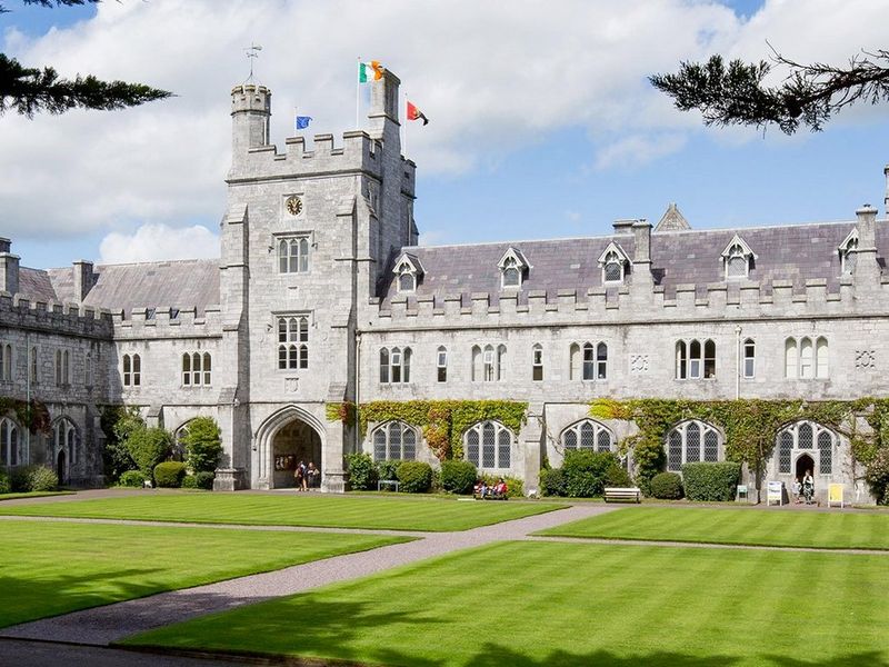 A panorama of the buildings of University College Cork in Ireland, set against a blue but cloudy sky.