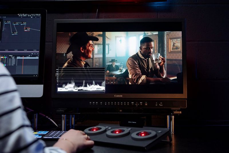 A large black reference display showing two men at a bar.