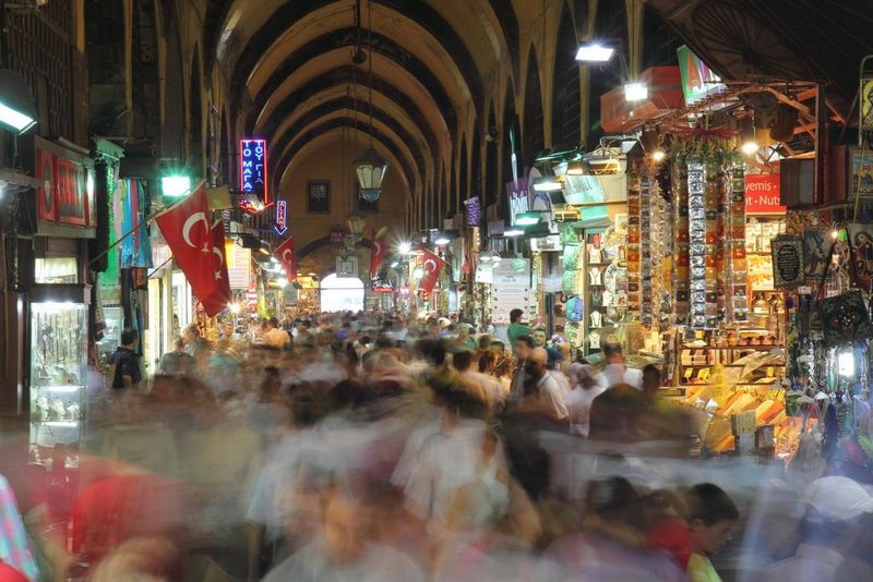 An indoor Turkish market. The low shutter speed has blurred the crowd, emphasising how busy the scene is.