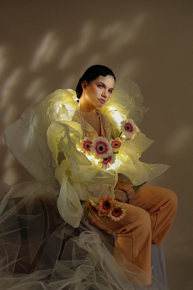  A portrait of a model wearing a yellow outfit covered with flowers. Taken by Guia Besana with a Canon RF 35mm F1.8 MACRO IS STM