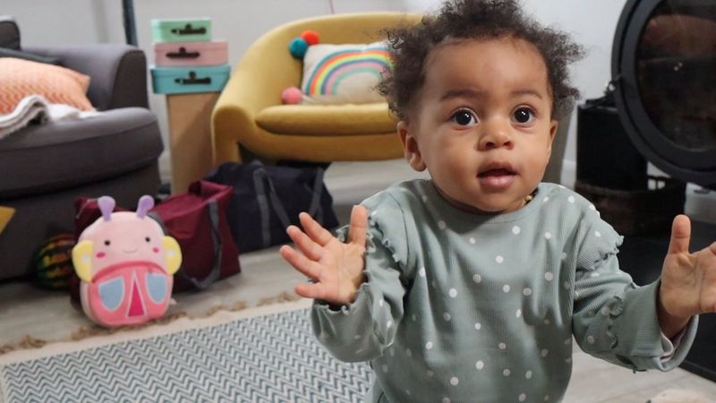 A video taken with the Canon EOS R100 of a toddler holding their hands up and walking towards the camera.