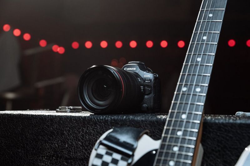 The Canon EOS R5 Mark II camera sat on top of an amp box with a guitar handle beside it. 