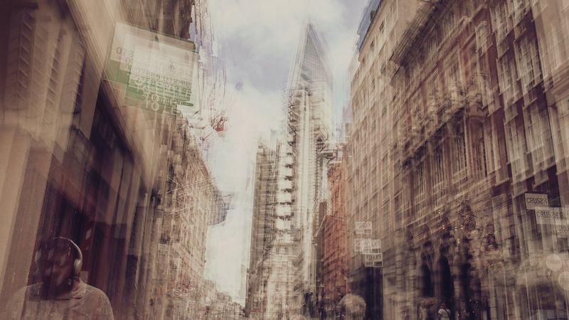 A city street with multiple exposures, creating a blurred, repeating effect.