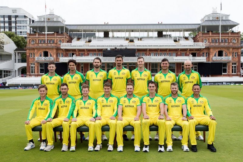 A group portrait of the Australian cricket team wearing yellow and green.