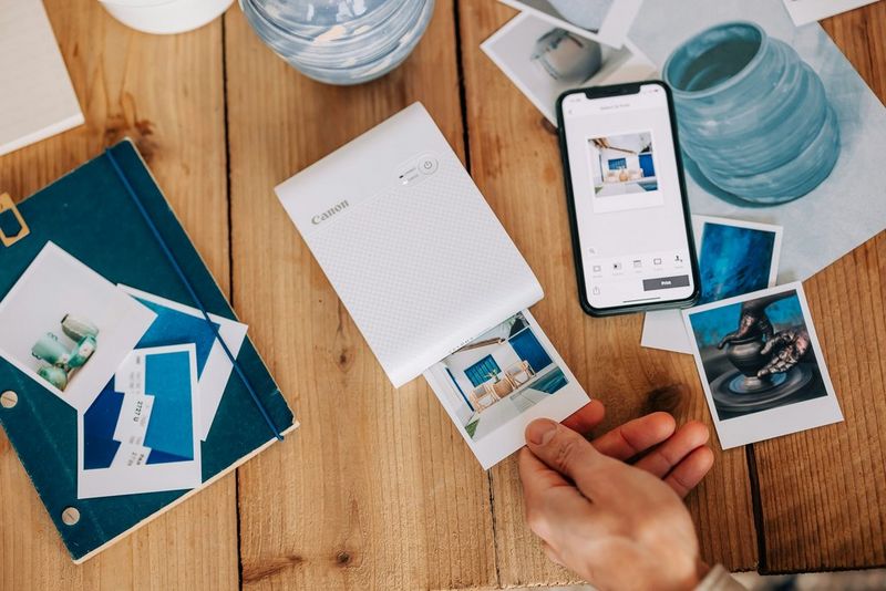A Canon SELPHY Square QX10 printing out images for a home décor mood board.