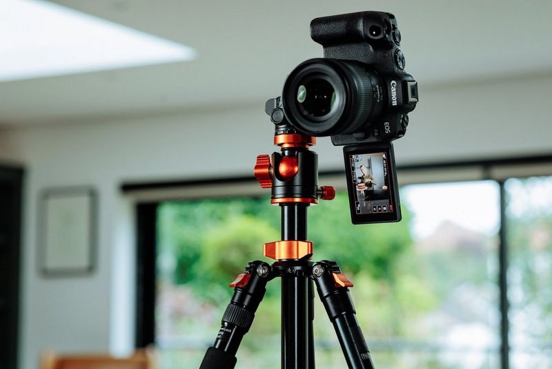 A Canon EOS R8 camera is arranged on a tripod at a 90° angle to record in portrait rather than landscape.