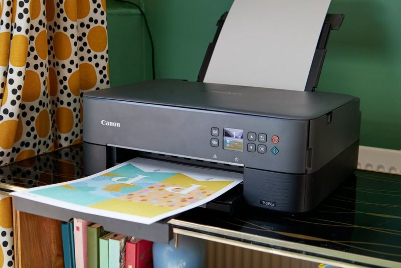 A print of a Canon Creative Park template emerges from a Canon PIXMA printer.