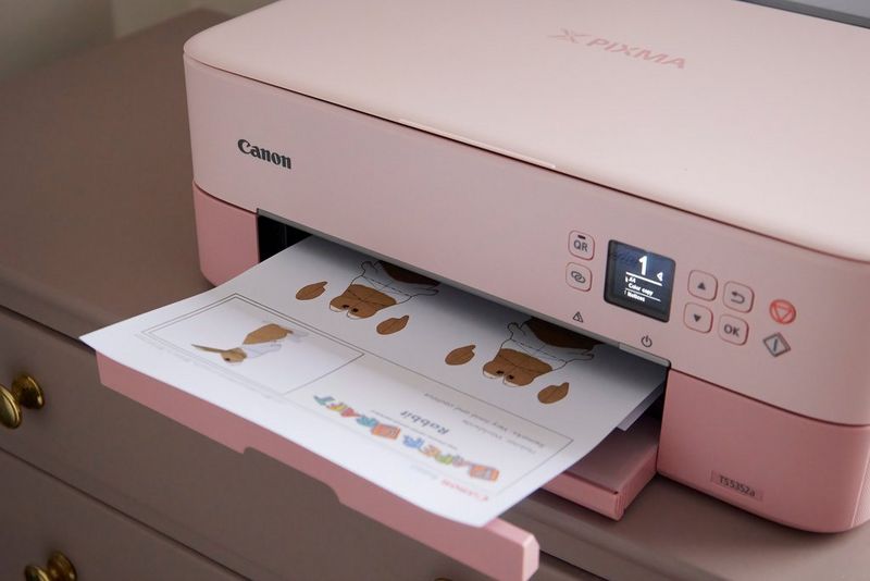 A Canon PIXMA printer with a Creative Park rabbit template in the output tray.