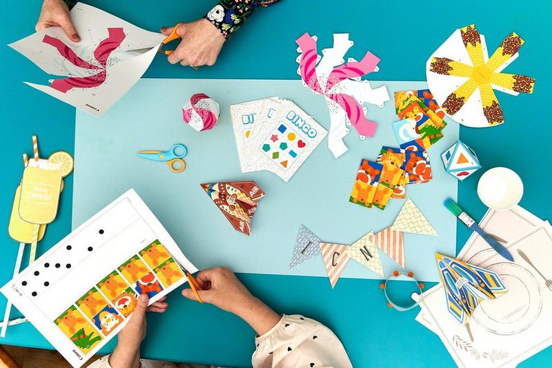 Shot from above, Creative Park templates and partly constructed papercraft models arranged on a table top.